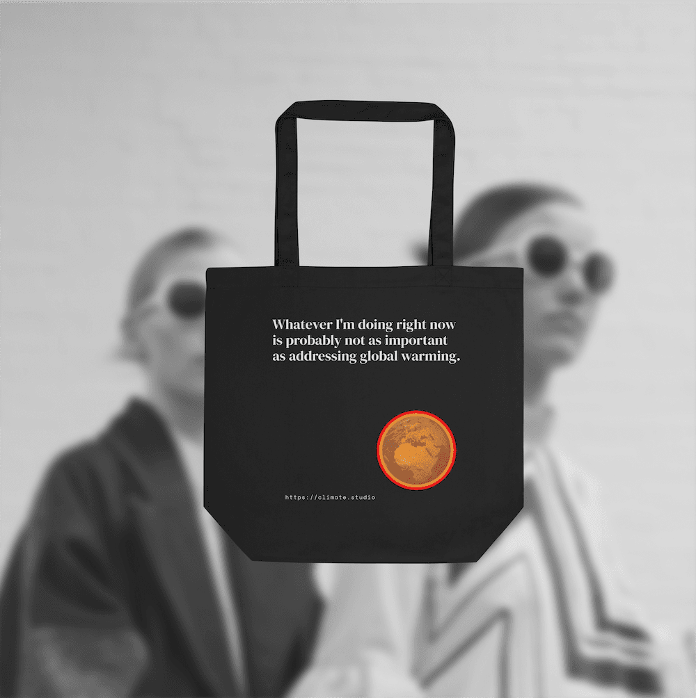 Black tote bag with climate message against fashion background