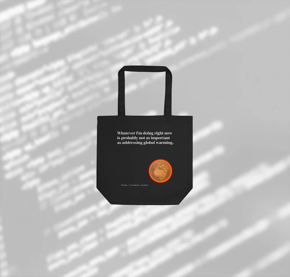 Black tote bag with climate message against code background