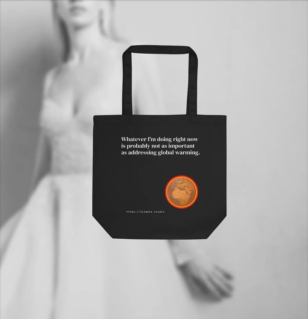 Black tote bag with climate message against fashion background