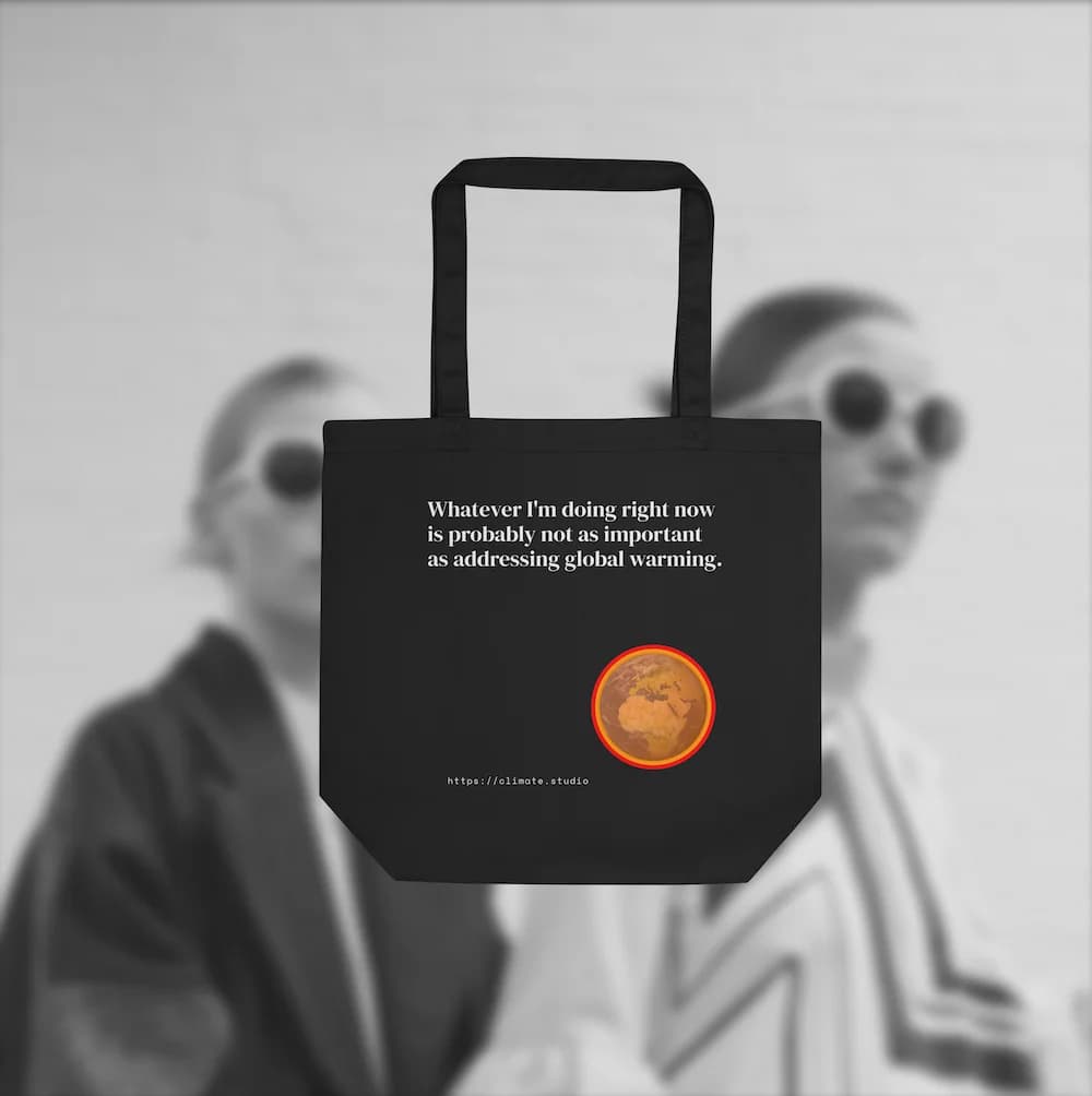 Black tote bag with climate message against fashion background