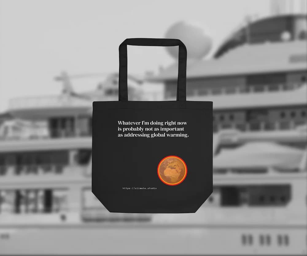Black tote bag with climate message against mega yacht background