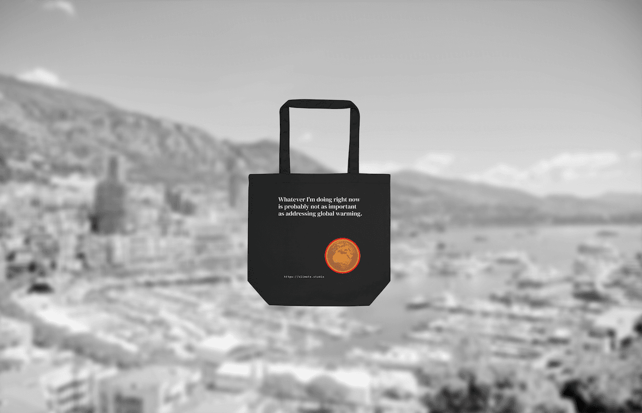 Black tote bag with climate message against Monaco background