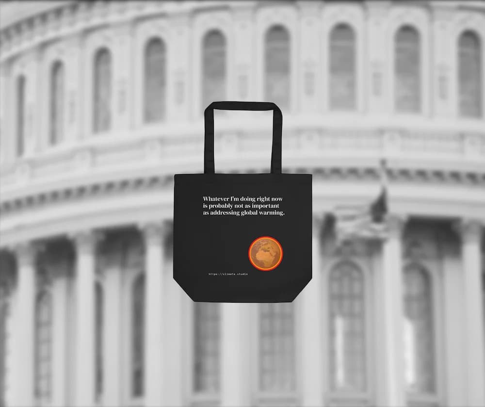 Black tote bag with climate message against US politics background