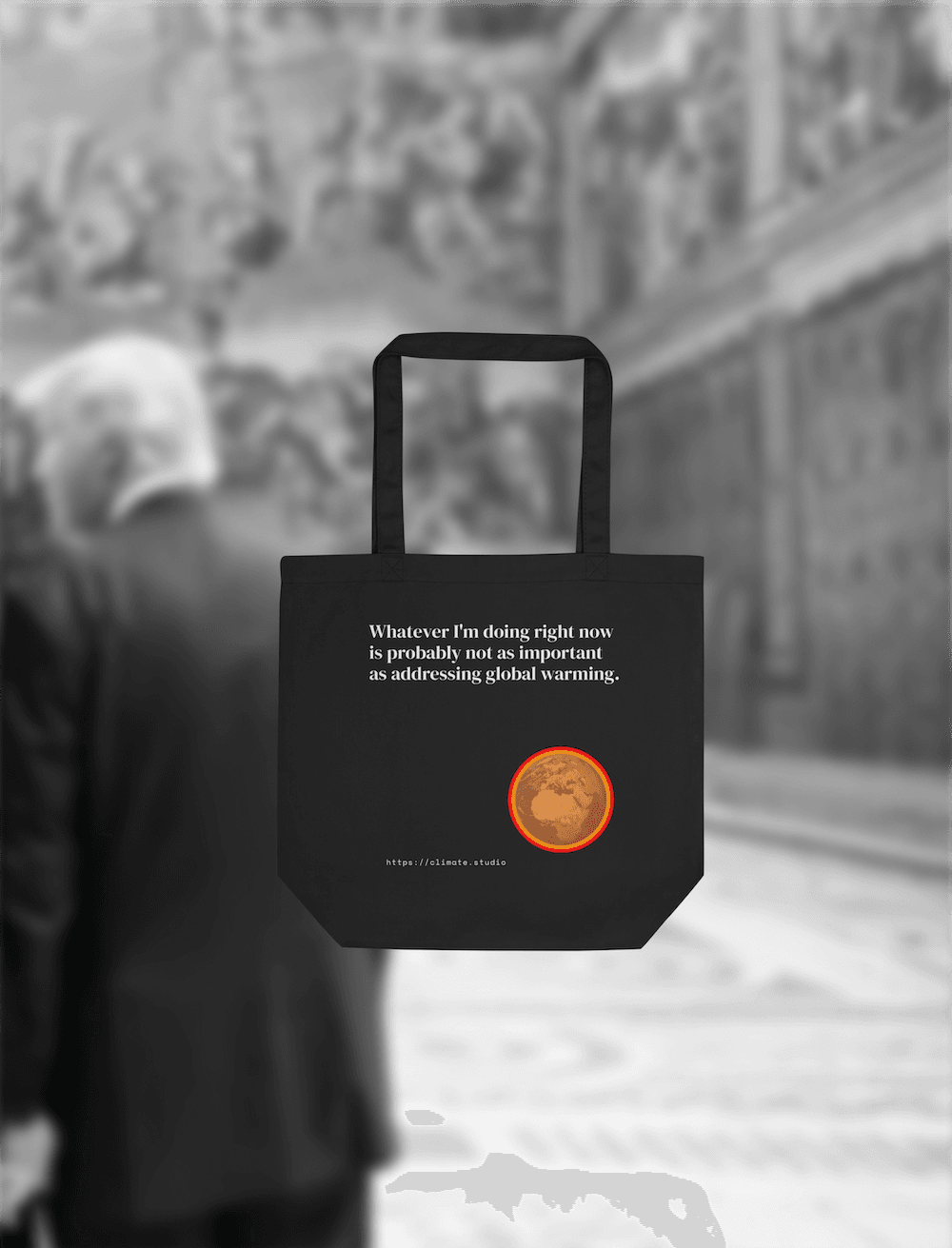 Black tote bag with climate message against Vatican background